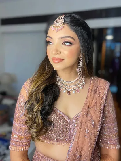 A side profile of Hetal's engagement look, highlighting the soft curls and glowing skin.
