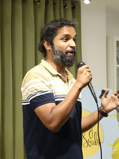 A performer sharing his thoughts and stories with the crowd.