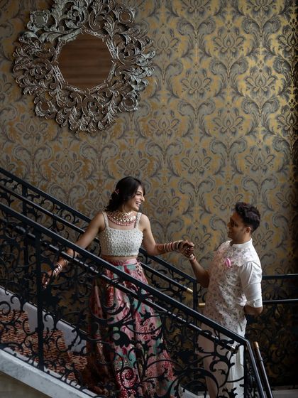 The couple shares a moment on a grand staircase, a classic and elegant setting for a wedding portrait.