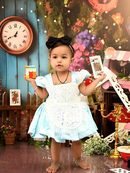 Standing tall in Wonderland. This theme allows for so many creative poses and interactions with the enchanting props.