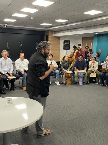 Leading a drum circle for the Adobe team. It's a fantastic way to break the ice, build team spirit, and get everyone involved in creating music together.