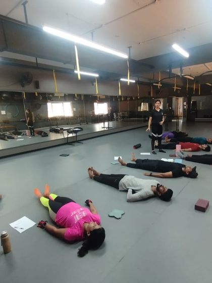 A moment of rest and recovery during an intense practical session. We teach our future trainers the importance of cooldowns and relaxation techniques for client success.