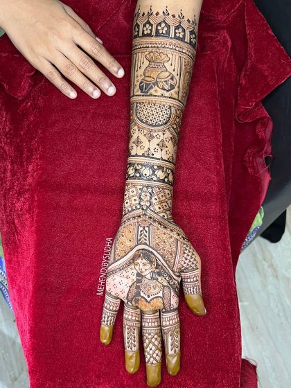 A close up of the bride's portrait on one hand, part of a larger design that tells her wedding story.