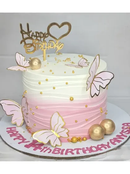 An elegant pink ombre butterfly cake for a 14th birthday. This basic vanilla cake is decorated with pink and gold butterflies, golden spheres, and a beautiful "Happy Birthday" topper.