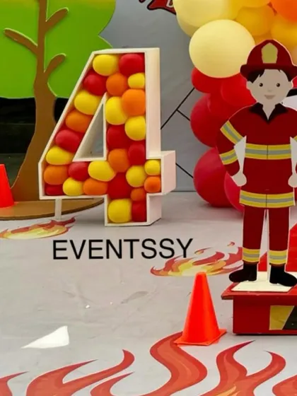 A detail shot of the balloon-filled marquee number "4" from the firetruck party. The red, yellow, and orange balloons mimic the colors of fire, tying into the overall theme perfectly.