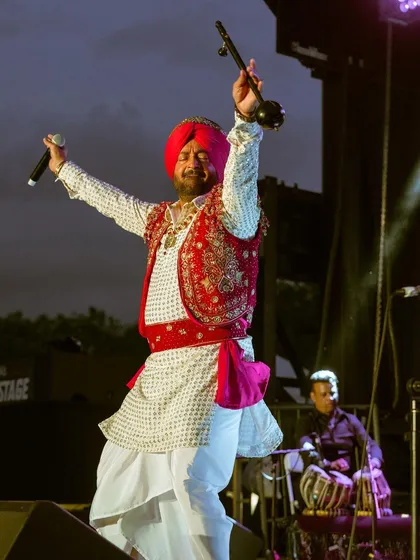 My events often feature incredible live performers. Here's the legendary Malkit Singh, the King of Bhangra, electrifying the SummerStage crowd. I love curating shows that bring together iconic artists and new talent.