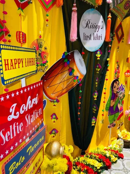 A detailed shot of the Lohri selfie station, highlighting the "Lohri Selfie Station" sign and the dhol cutout, adding a fun, interactive element to the party.