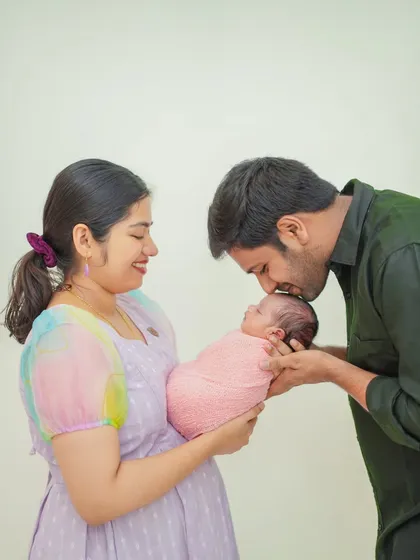 Capturing the pure love and connection in your family's first portrait is essential. In my studio, I guide families into natural, heartfelt poses that result in timeless images like this one.