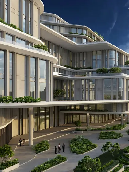 This structure is a bold statement with sweeping curves and thoughtful design. The heart of the building is a central atrium, a verdant amphitheater bathed in cascading natural light that adds an enigmatic charm to the interiors.