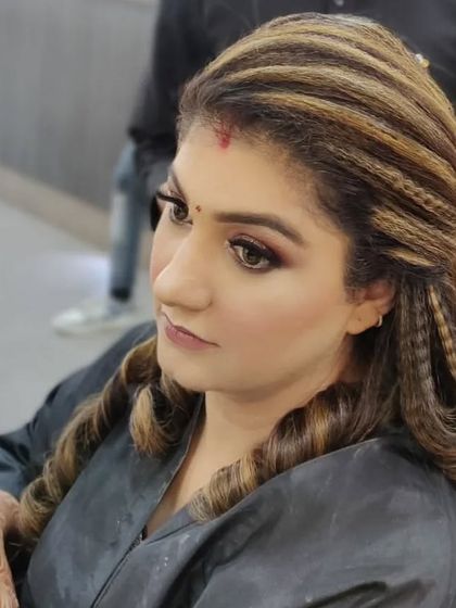 A modern and trendy hairstyle featuring a mix of crimped textures and soft curls. This look adds volume and dimension, perfect for a cocktail party or reception.