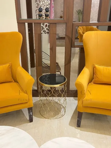 A set of two high-back armchairs in a sunny yellow velvet. Their simple, elegant silhouette and vibrant color make them a cheerful and stylish addition to any living space.