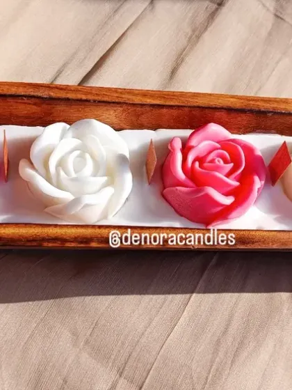 My wooden boat candles offer a rustic yet elegant charm. This piece features five beautiful rose-shaped candles, alternating in pink and white, set in a polished wooden boat tray.