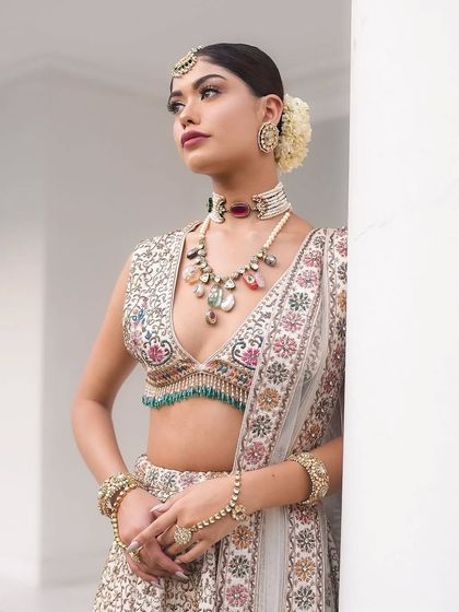 A close-up on the unique, multi-gemstone necklace that perfectly complements the colors in the lehenga.