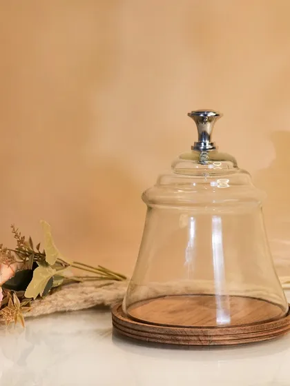 A glass cloche with a wooden base, styled with a single rose. This simple, elegant composition highlights the product's use as a decorative display piece.