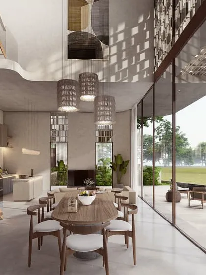 The dining and living areas in the Pavilions in the Fields project are designed as a single, expansive volume. The space opens completely to a patio and pool, offering uninterrupted views of the vast paddy fields beyond.