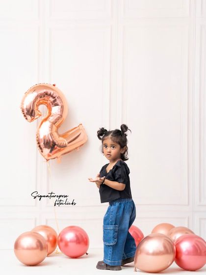 A wider shot of the second birthday setup, showing the simple yet elegant decor that lets the child's personality shine.
