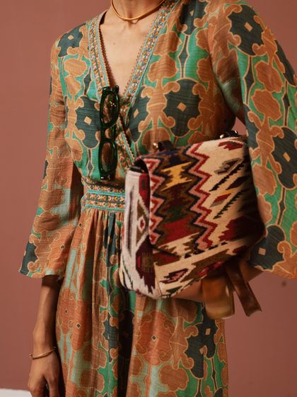 A detail shot focusing on the ikat-inspired bag and the intricate print of the Ritu Kumar dress. I believe in highlighting the unique accessories that complete an outfit.