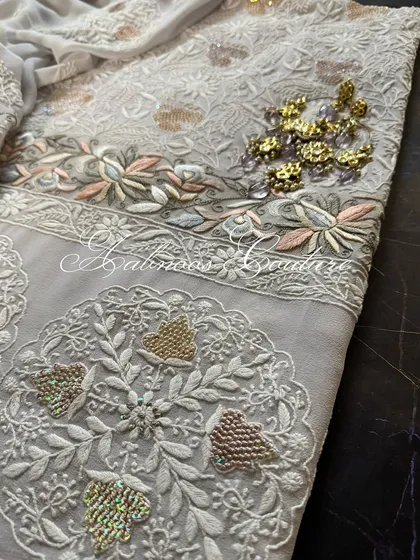 A flat-lay of the suit, showing the coordinated design of the kurta and dupatta.