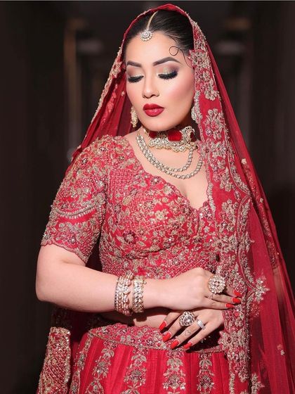 The complete look under the veil. This classic bridal style with a bold red lip is perfect for making a grand entrance and creating memories that last a lifetime.