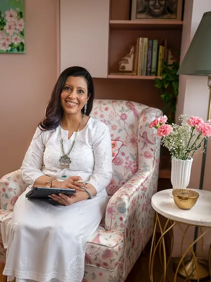 A branding photo should tell a story about what you do. Here, seated in her own cozy office chair, she looks ready to connect, creating a sense of trust and comfort for potential clients.