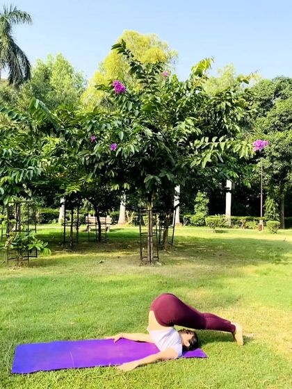 A beautiful Halasana (Plough Pose) by my student in the park. This pose stretches the entire spine and shoulders, providing deep relief from back tension.