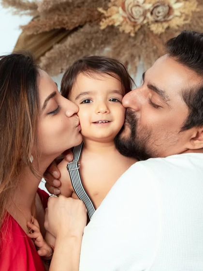 A moment filled with love and affection. Kisses from mom and dad make for the sweetest and most cherished family portraits.