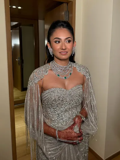A full-length view of this breathtaking silver gown. The makeup is glamorous and sophisticated, designed to match the high-fashion feel of the outfit.
