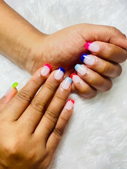 Another shot of the neon French tip nails. The bright colors are so cheerful and make a bold statement, while the classic French style keeps it looking chic.