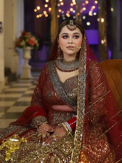 A seated portrait of the bride, looking like royalty. The lighting and her pose perfectly capture the elegance of her bridal look.