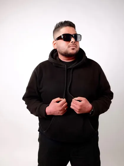 Adjusting my hoodie, a casual but stylish look. My personal style is part of the overall vibe.