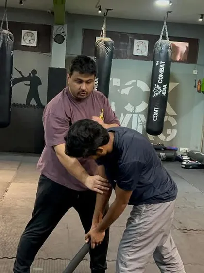 This shows a disarming technique where I use leverage to strip the stick from the attacker's grip. It's a fast, efficient move that follows the initial block and counter-strike.