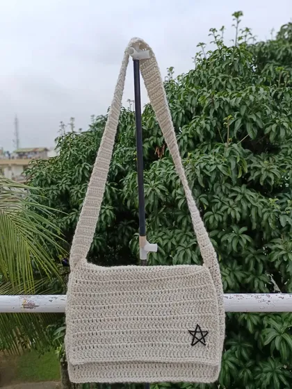 Another shot of the unisex star crossbody bag, highlighting its simple, functional design and long strap.