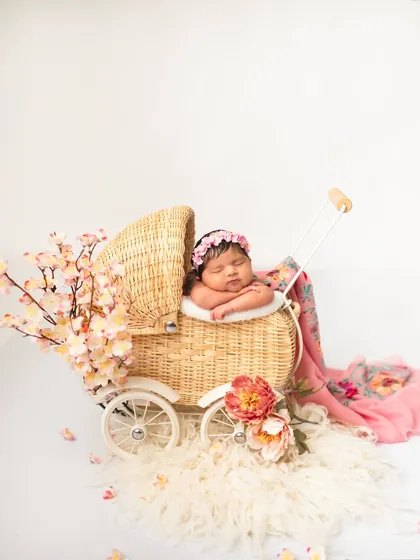There is nothing more precious than a brand new baby. For my newborn photography sessions, I love using classic props like this wicker pram and soft florals to create a timeless, peaceful portrait of your little one.