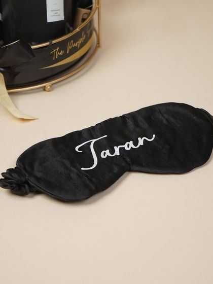 A personalized black satin eye mask for him, because men deserve to be pampered too.