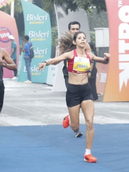 Crossing the finish line at the Vedanta Delhi Half Marathon. This moment captures the raw emotion and determination of racing, pushing through pain and fatigue to achieve a goal.