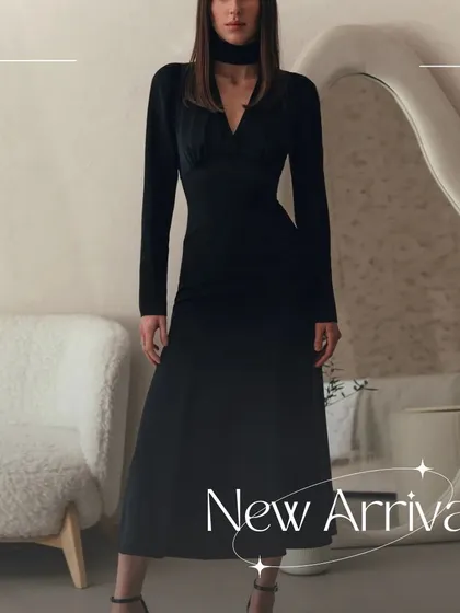 A full-length shot of the Slyther dress, showcasing its complete look. The combination of the choker neck and long sleeves is incredibly chic.