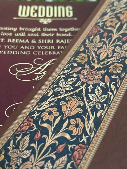 A detail shot of the intricate floral border that runs along the inserts of the deep blue and maroon suite.