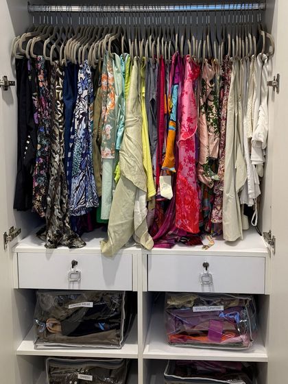 The final result is a wardrobe where every item has a designated home. We've introduced hanging space and clear storage solutions to make the closet both beautiful and functional.