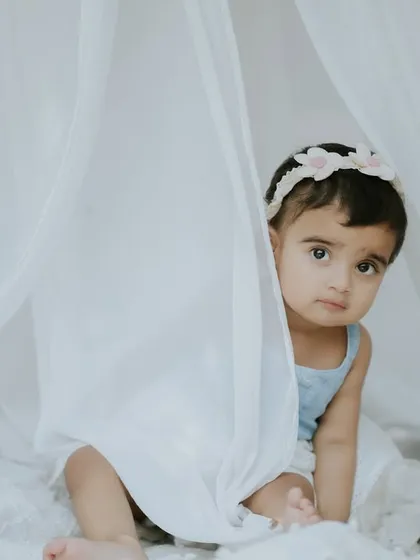 A curious peek from the little one. The soft, dreamy light of the outdoor setting is just beautiful.