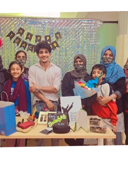 A group photo with students and parents on Teacher's Day, highlighting the family-like bond we share.
