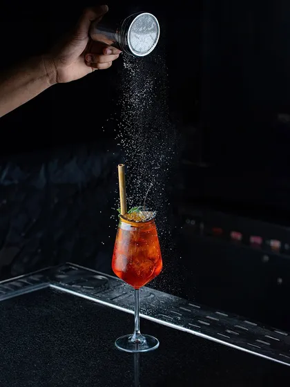 Blending unique ingredients with creativity and passion. Here, a final dusting of powder adds another layer of aroma and texture to one of our spritz-style cocktails.