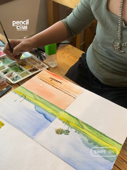 A student practices different watercolor wash techniques. These foundational exercises are essential for anyone looking to master the medium, from hobbyists to professionals.