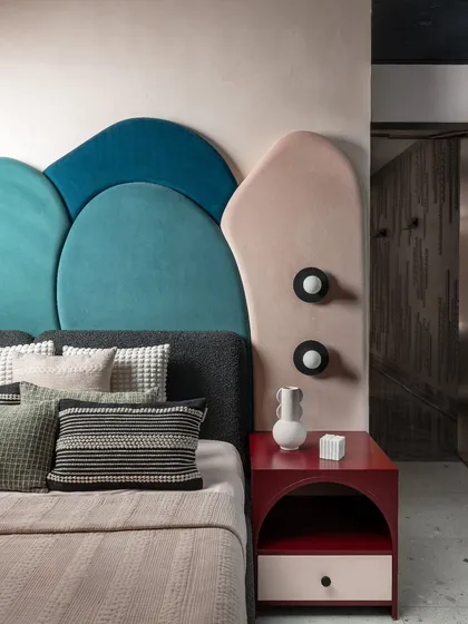 We love designing spaces that reflect individual personalities. This custom-designed headboard in the daughter's bedroom of the Scarlet Horizon project uses organic, layered shapes in bold teal and soft pink velvet. It’s a playful yet chic element that makes the room truly one of a kind.