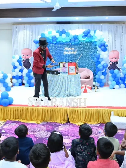 A wide shot of my stage setup for a Boss Baby-themed birthday. I command the stage, ensuring all the kids have a great view and are completely captivated by the magic.
