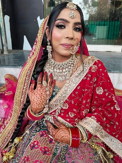 A close-up portrait of the bride, highlighting the flawless makeup application and beautiful traditional jewelry.