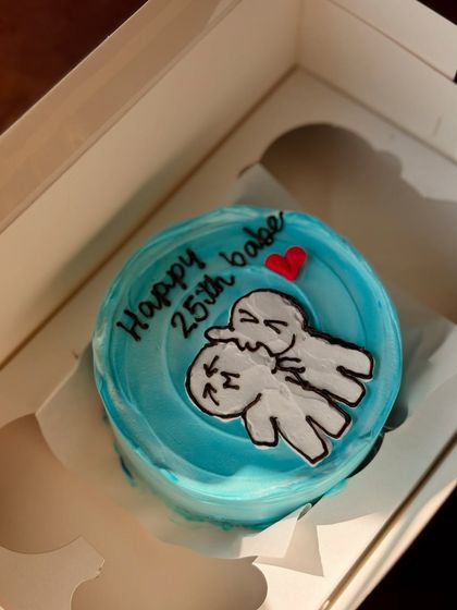 An oh-so-cute bento cake for a 25th birthday, featuring two cartoon characters in a loving hug. The bright blue background makes the design pop.