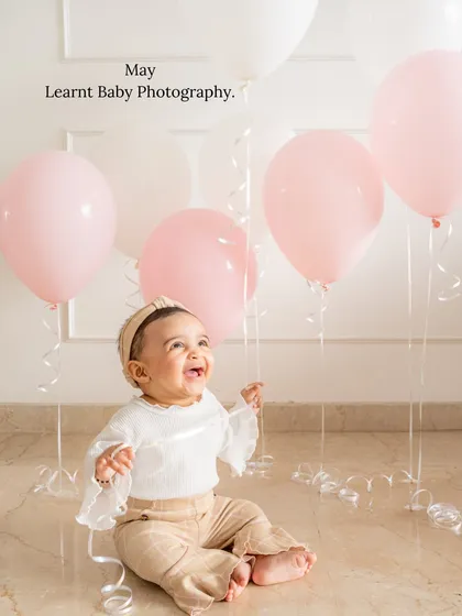 A baby's pure joy is the best thing to capture. For this milestone photo, we used simple balloons to add a touch of celebration. My goal is to create a fun and relaxed atmosphere where your little one's personality can truly shine.