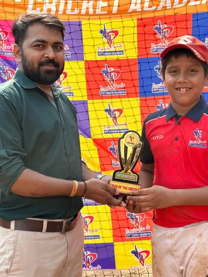 A Man of the Match from the U-10 PTPL 2024 proudly holds his trophy alongside one of our coaches.