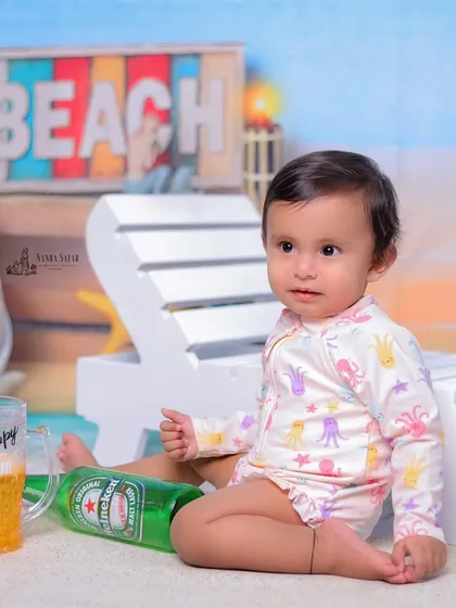 A close-up of our beach baby enjoying a pretend drink. These playful interactions with props result in some of the most memorable and funny shots.
