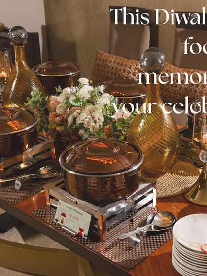 A warm and inviting Diwali buffet display featuring beautiful copper-toned serving dishes. The text overlay, "This Diwali, let the food be as memorable as your celebration," perfectly captures my philosophy.
